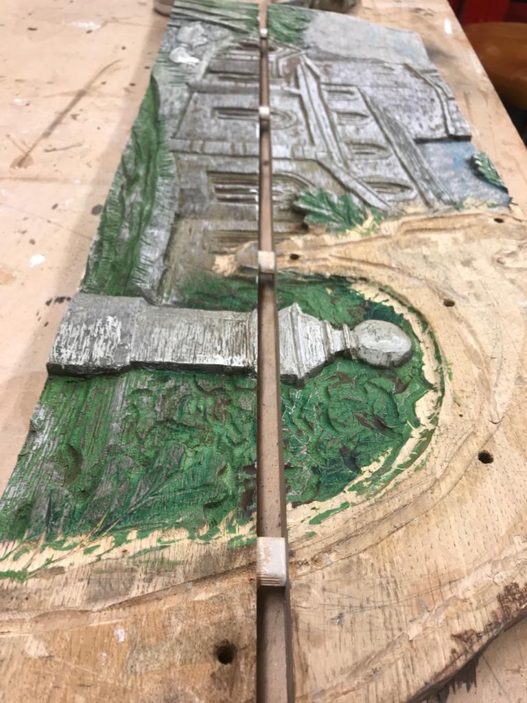 Sections of the village sign being restored