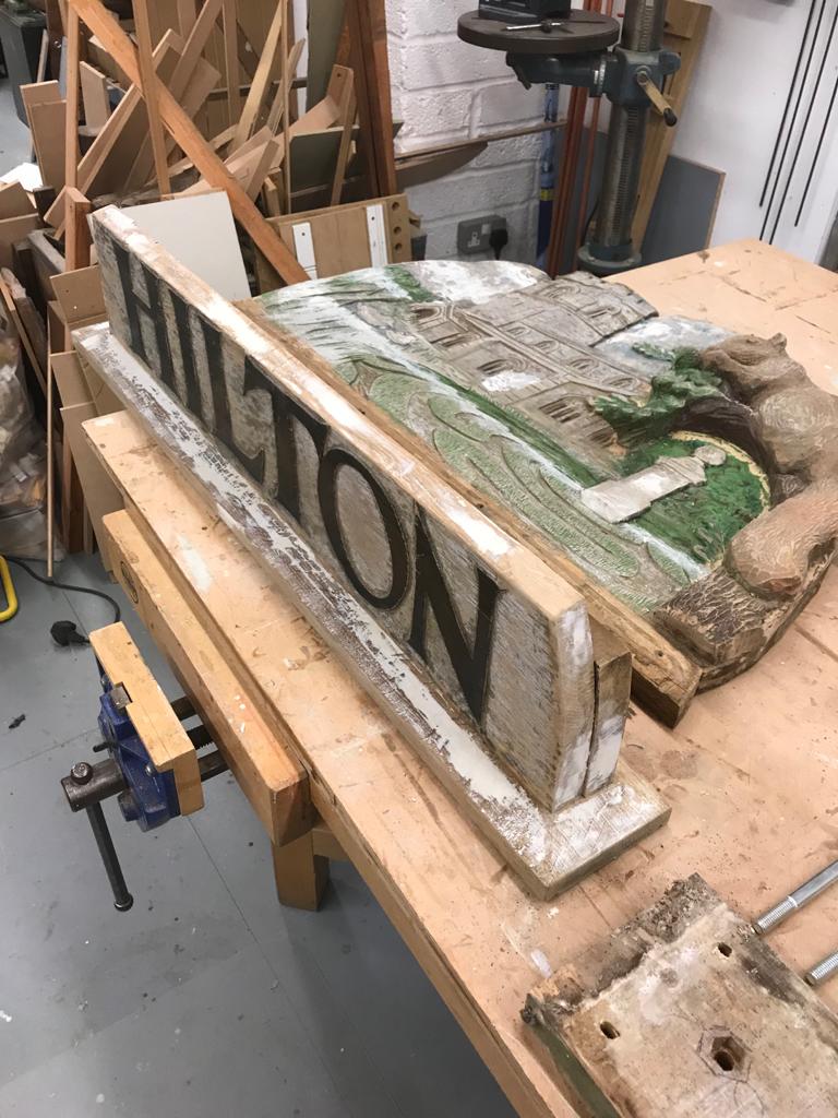 The village sign being reassembled